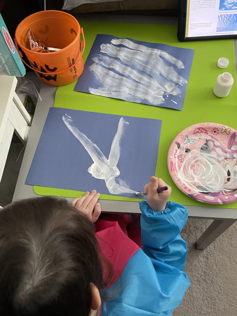 painting clouds as part of the rabbit trails preschool curriculum